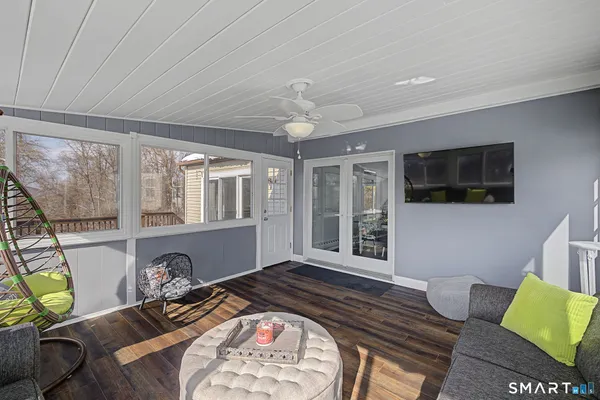 a bed room with furniture and a flat screen tv