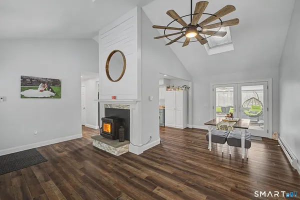 a living room with furniture wooden floor and a fireplace