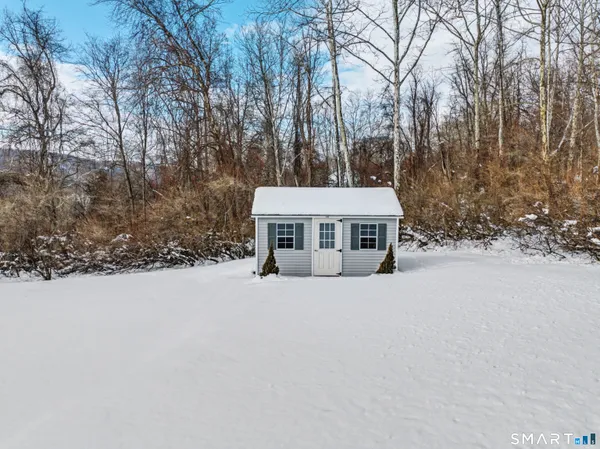 a view of a house with a yard covered in snow