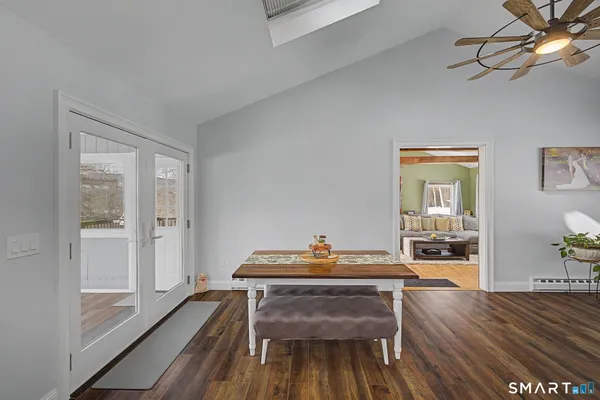 a workspace with wooden floor and a chandelier fan