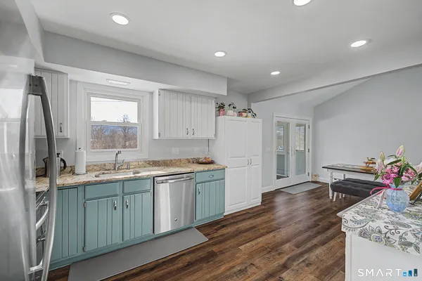 a kitchen with refrigerator and window