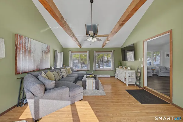 a living room with furniture and a chandelier