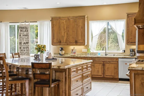 a bathroom with a granite countertop sink mirror and double