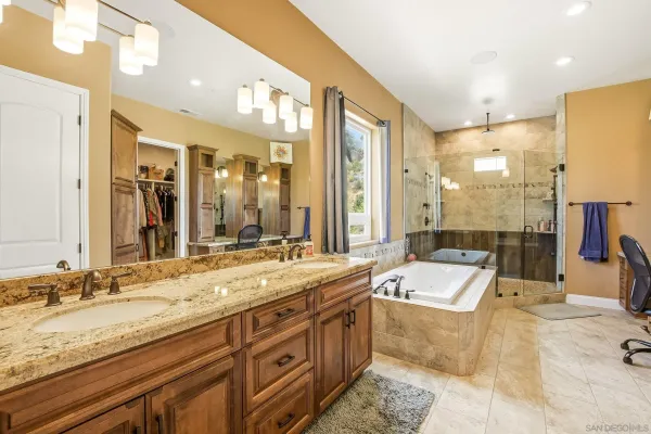 an aerial view of a house with swimming pool and mountains