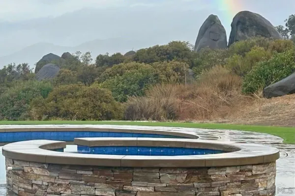 a living room with furniture kitchen view and a window