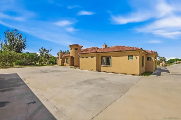 a spacious bathroom with a granite countertop tub and a large mirror