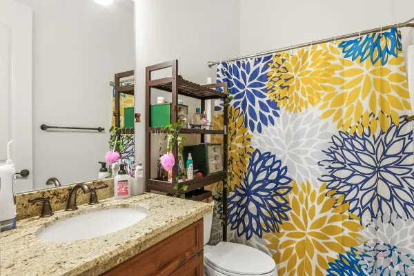 an aerial view of residential houses with outdoor space and trees