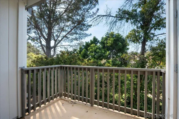 a balcony with trees in front of it
