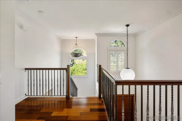 a view of hallway with furniture and wooden floor
