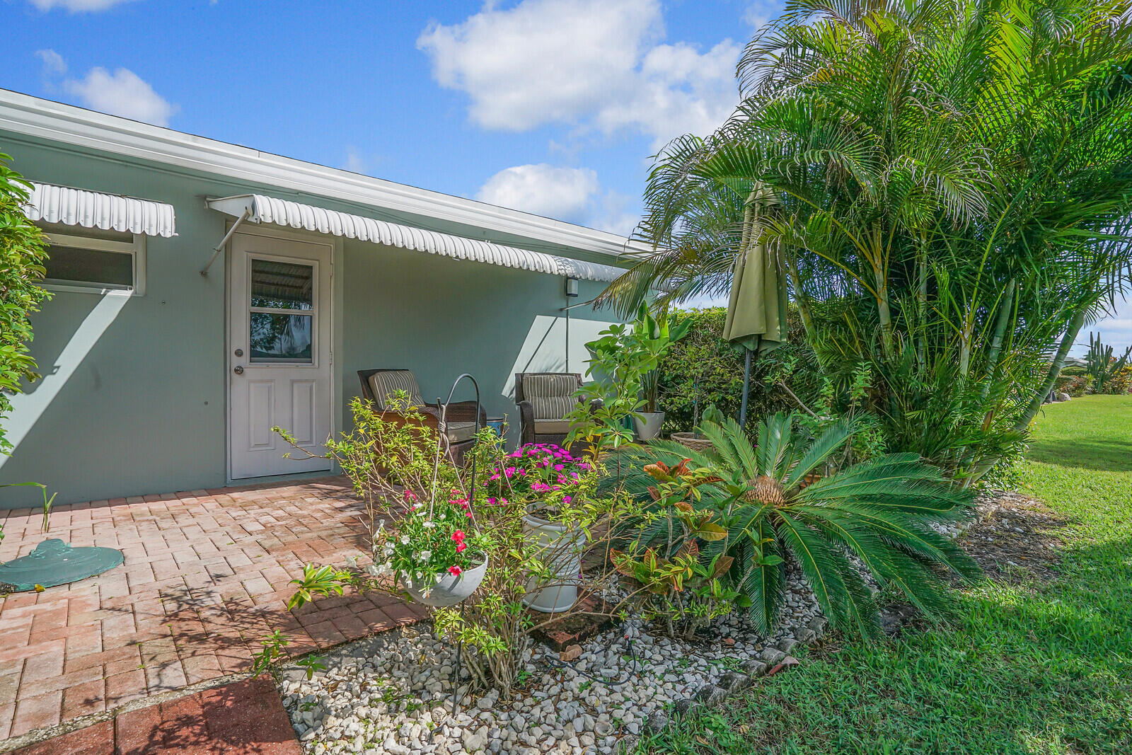 202 West High Point Terrace, Unit A Delray Beach, FL 33445 - Photo 27 of 55 a front view of a house with a yard