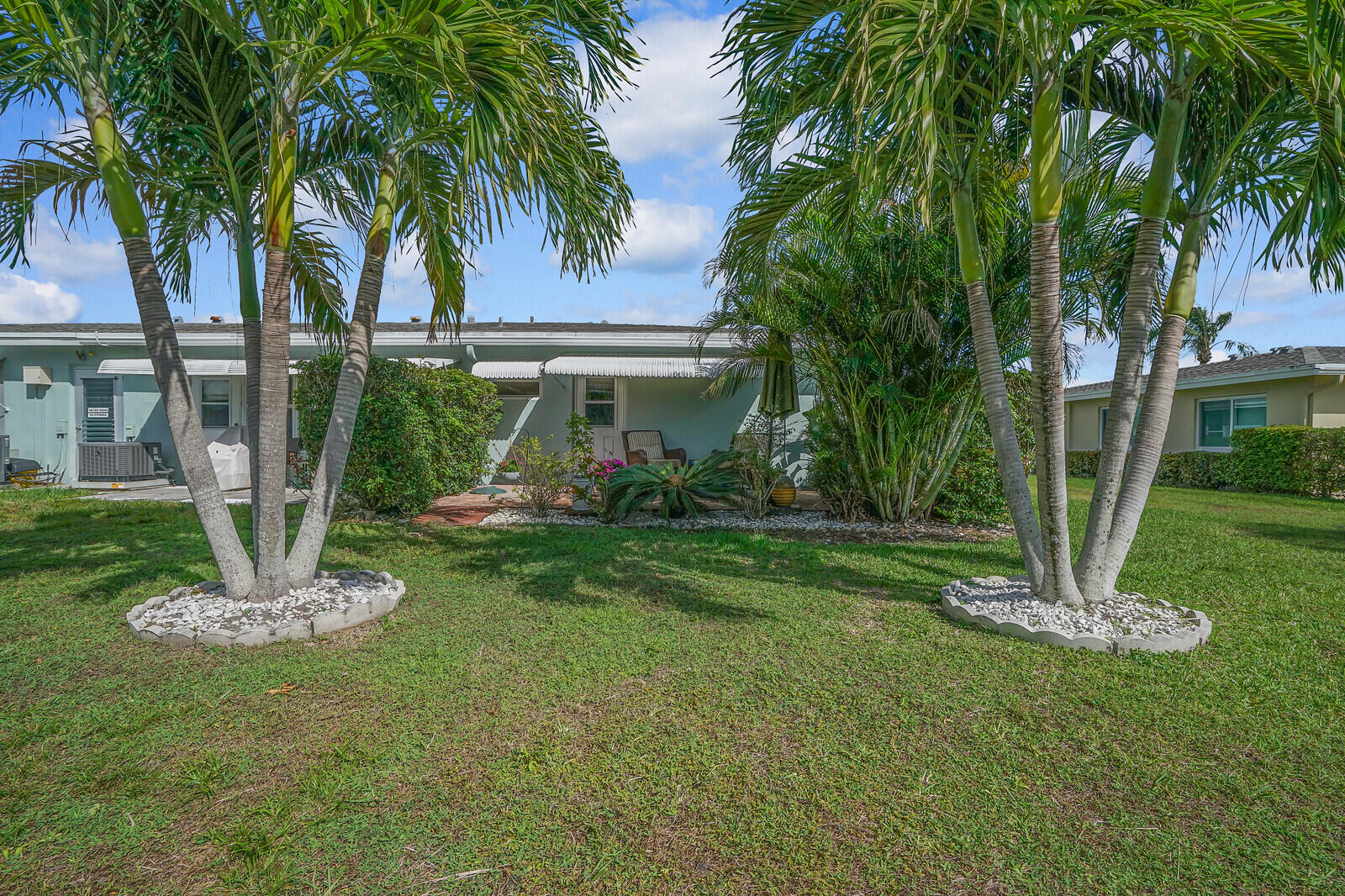 202 West High Point Terrace, Unit A Delray Beach, FL 33445 - Photo 29 of 55 a view of a house with a yard and a tree