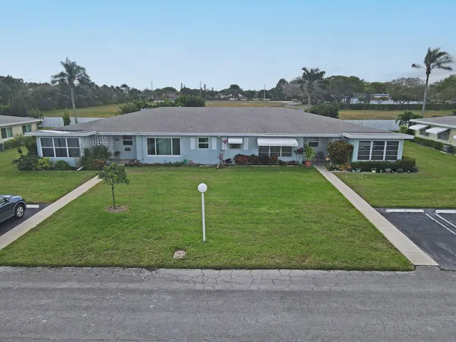 a aerial view of a house with swimming pool and a yard