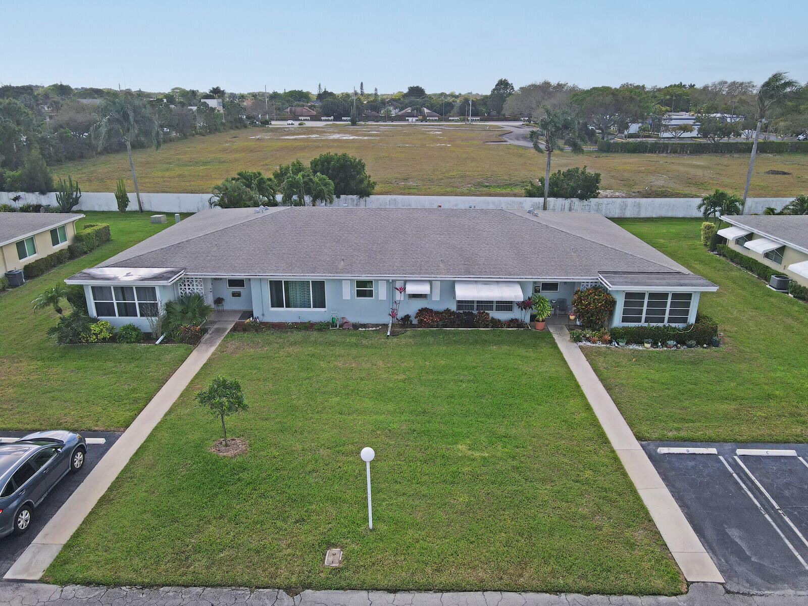 202 West High Point Terrace, Unit A Delray Beach, FL 33445 - Photo 32 of 55 a aerial view of a house with swimming pool and a yard