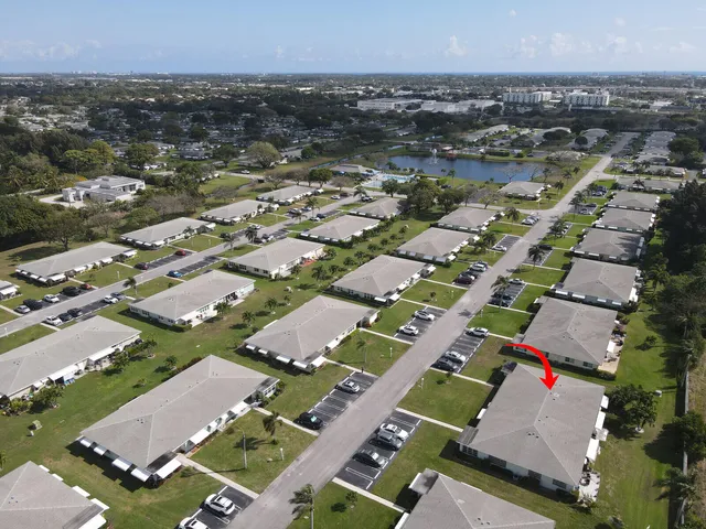 an aerial view of residential houses with outdoor space and swimming pool
