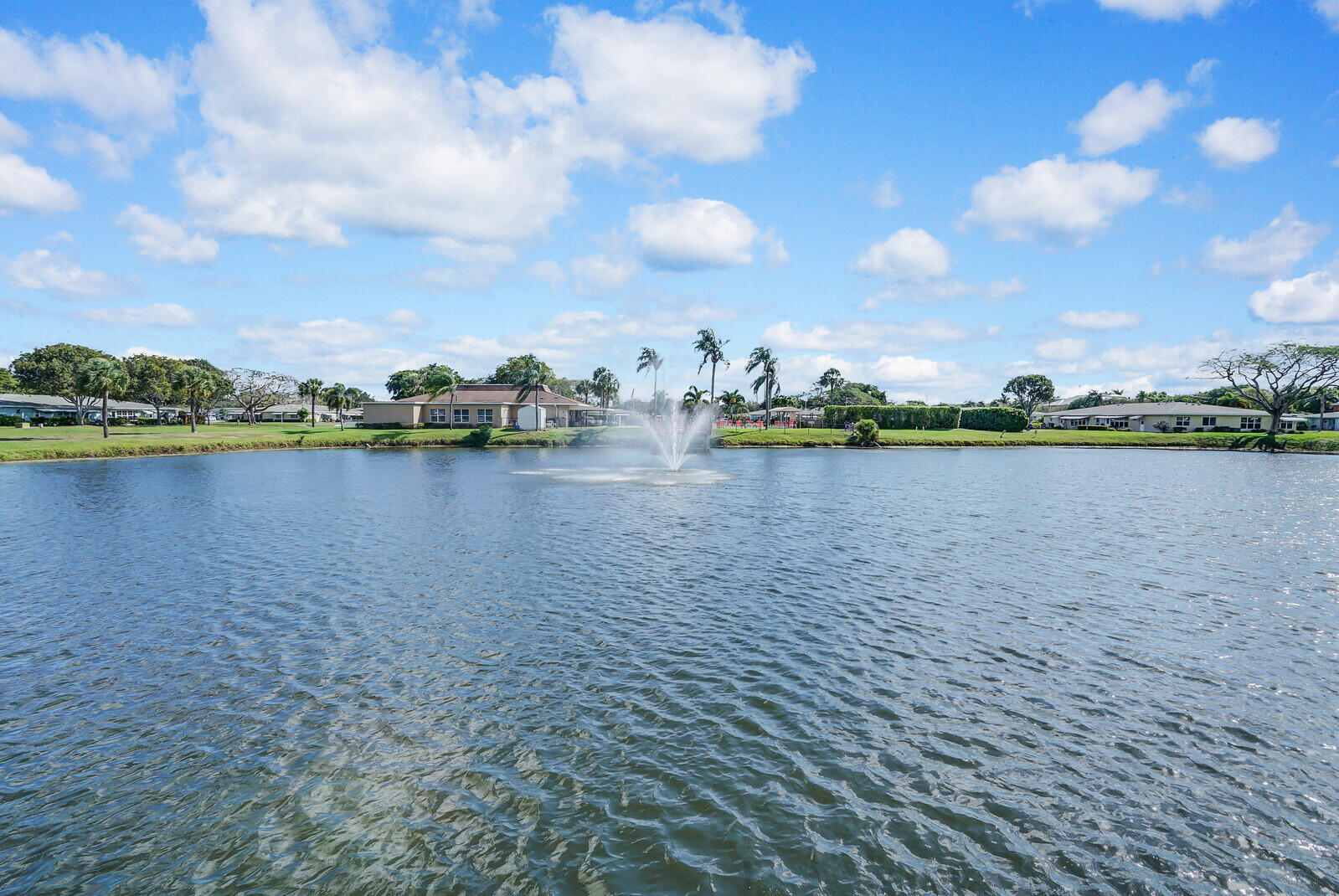 202 West High Point Terrace, Unit A Delray Beach, FL 33445 - Photo 55 of 55 a view of a lake with houses in the back