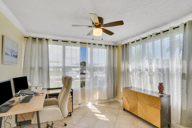 a view of a livingroom with workspace and a window