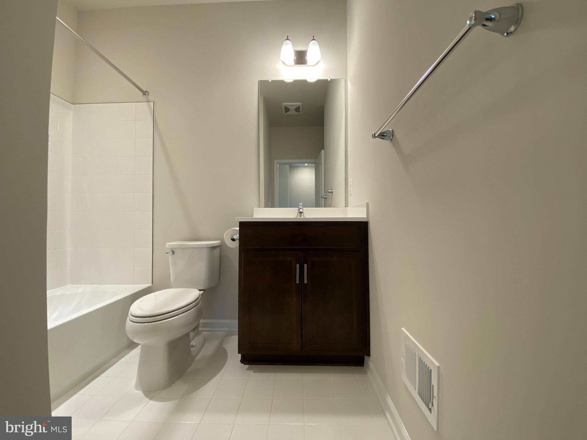 1659 Magundy Street Frederick, MD 21701 - Photo 13 of 16 a bathroom with a toilet sink and mirror