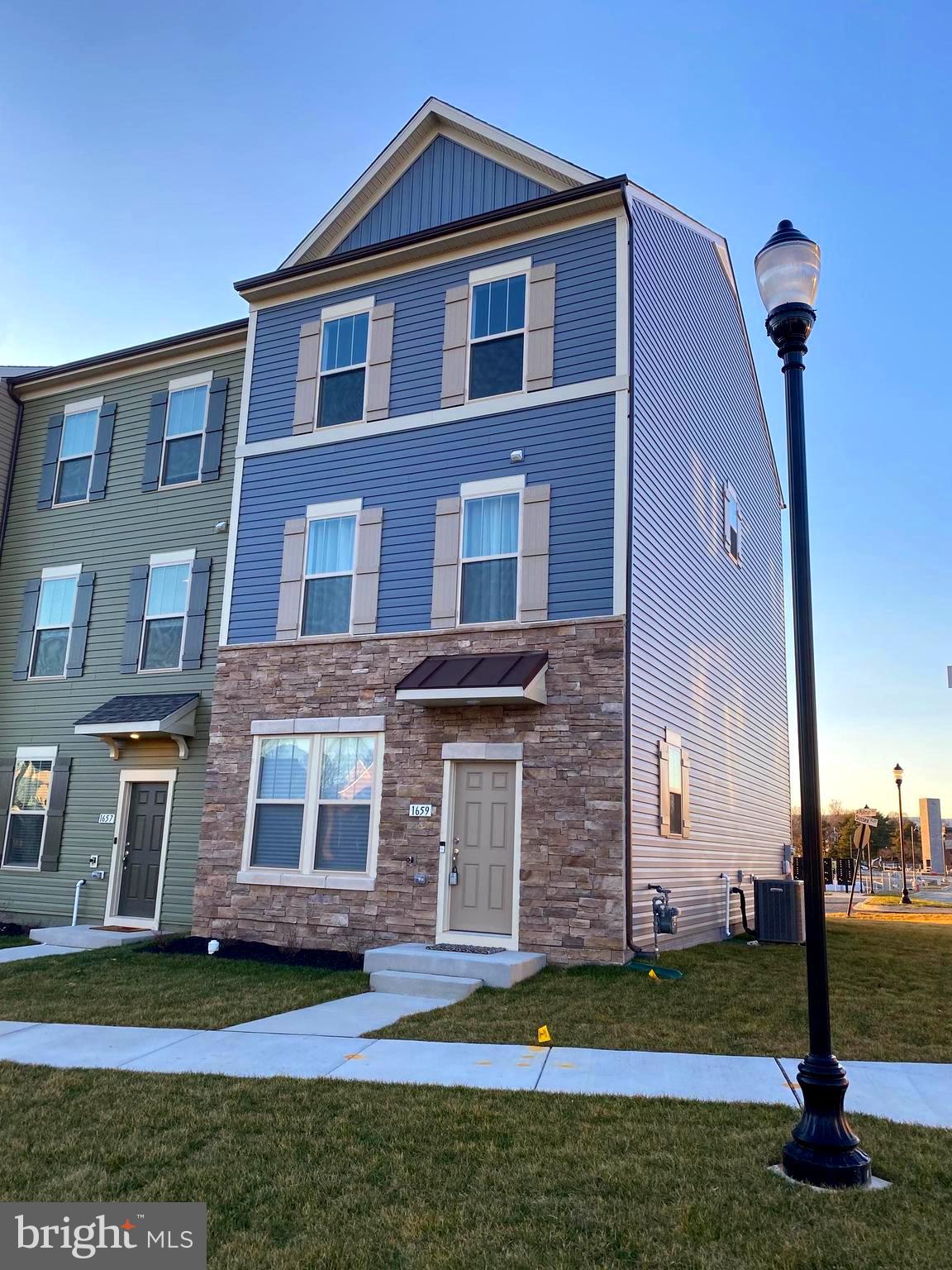 1659 Magundy Street Frederick, MD 21701 - Photo 2 of 16 a front view of a house with a yard