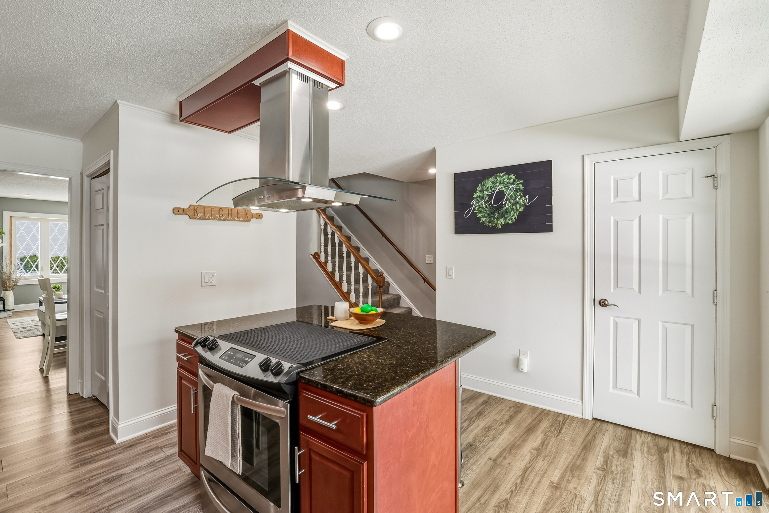 20 Wolf Hill Road, Unit 1A Wolcott, CT 06716 - Photo 12 of 36 Island with seating, stovetop and modern hood