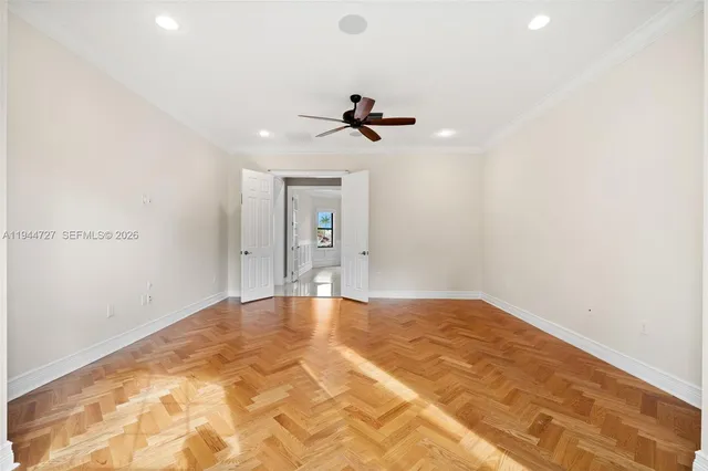 a kitchen with kitchen island a counter top space appliances and a ceiling fan