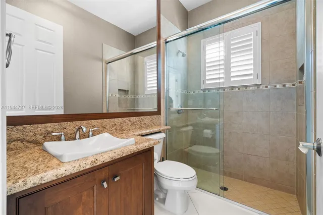 an empty room with windows and chandelier