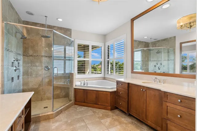 a view of a house with a big yard potted plants and palm trees