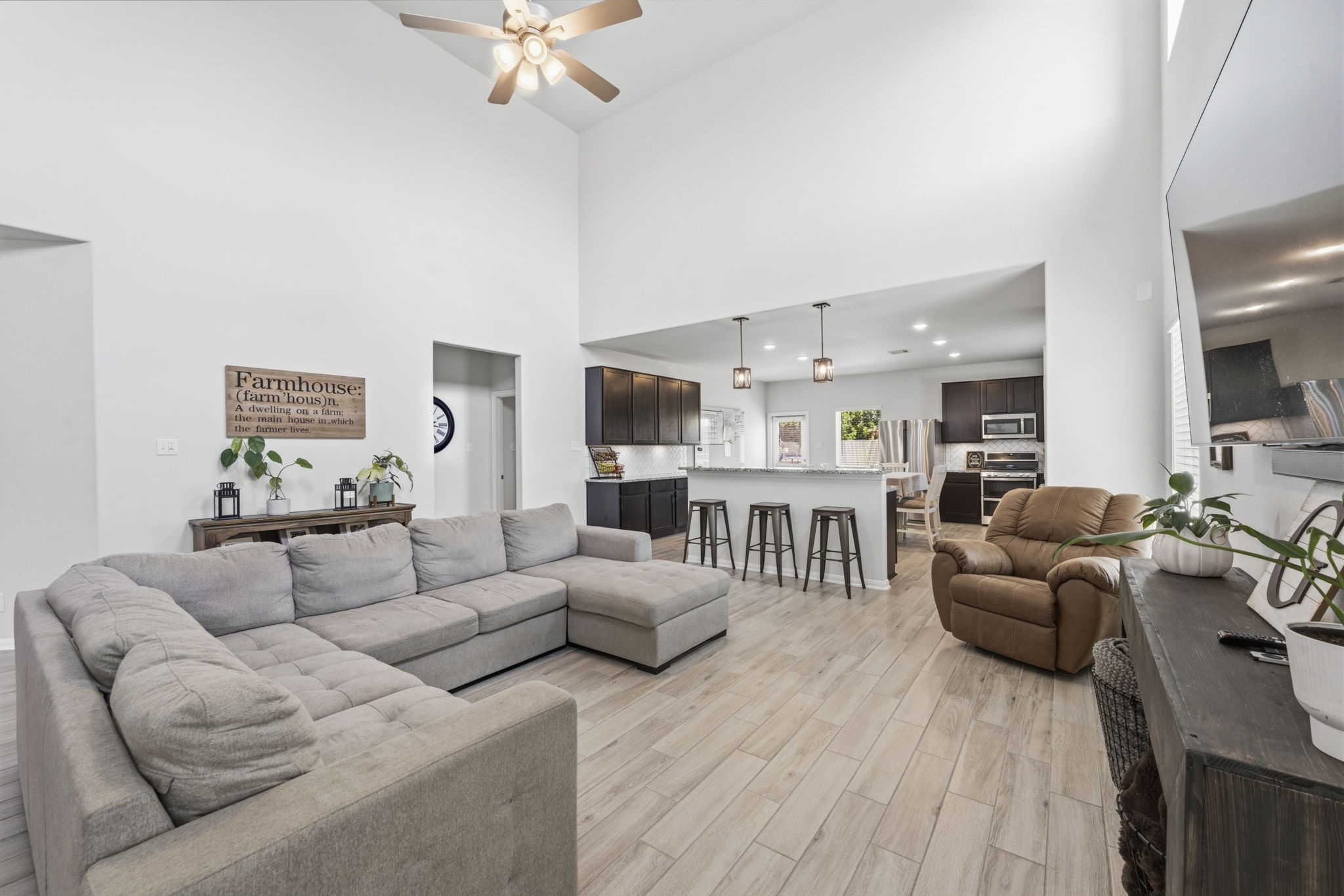 2401 Abbot Brk Drive Rosharon, TX 77583 - Photo 49 of 50 A breathtaking view of the home’s elegant design unfolds as the family room seamlessly transitions into the beautifully appointed kitchen. This thoughtfully designed open-concept floor plan offers the perfect blend of comfort and functionality, making everyday family living effortless while providing an exceptional setting for entertaining guests.