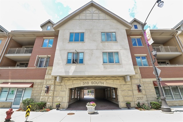 a front view of a building with parking