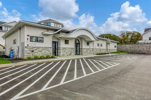 a spacious bathroom with a granite countertop sink and a bathtub