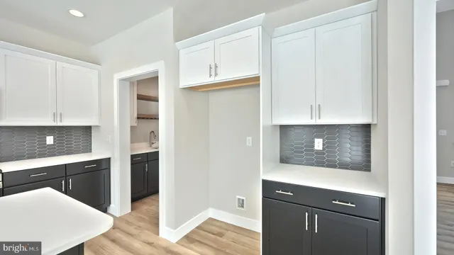 a kitchen with white cabinets