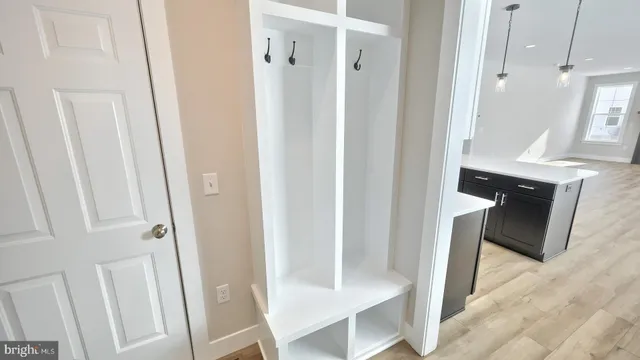a view of a hallway with wooden floor and entryway