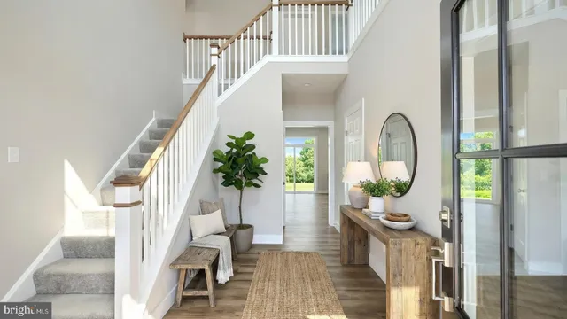 a view of entryway and hall with wooden floor