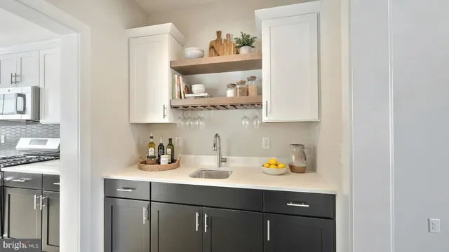 a kitchen with stainless steel appliances a sink and cabinets