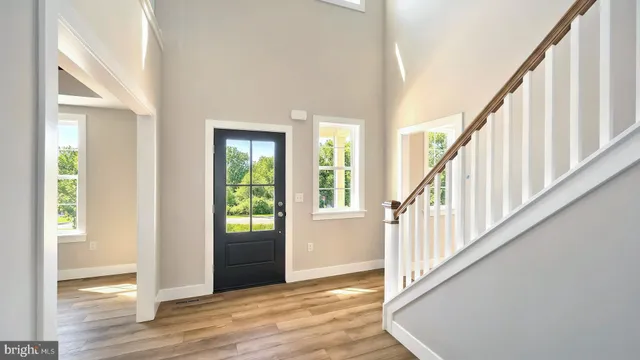 a view of an entryway with wooden floor and door