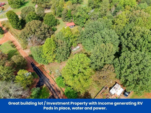 an aerial view of a residential houses covered in trees