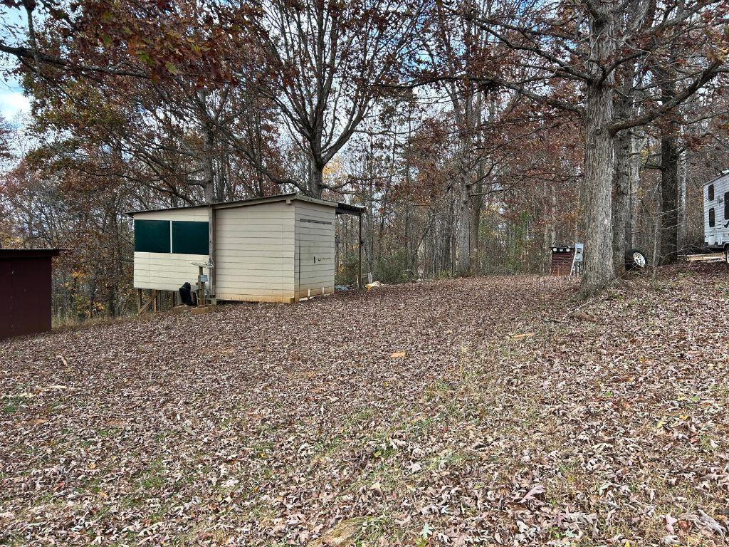 99 Rocket Drive Cleveland, GA 30528 - Photo 5 of 12 a backyard of a house with large trees