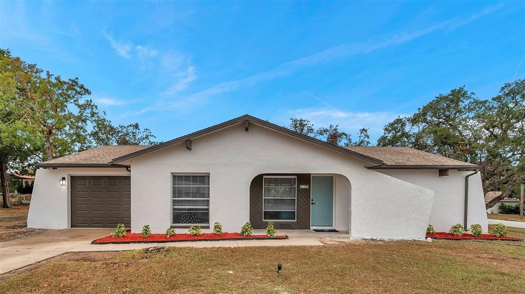 11199 Mayflower Road Spring Hill, FL 34608 - Photo 1 of 1 Beautiful front view of the home, offering a welcoming entrance and a glimpse of the spacious property.