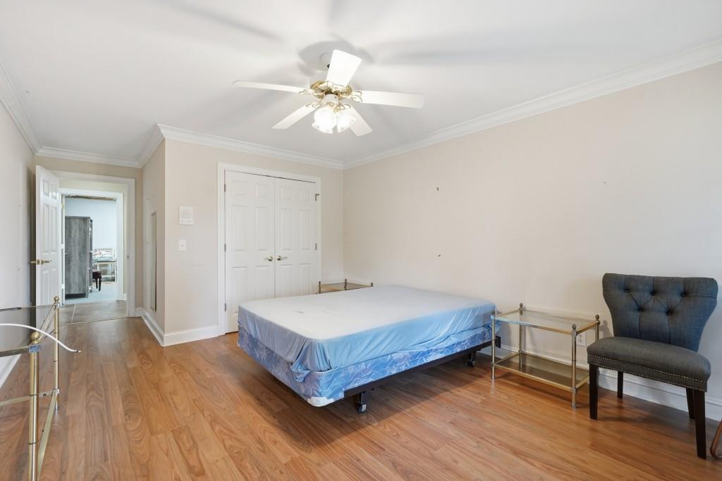 774 Bray Road Southwest Calhoun, GA 30701 - Photo 58 of 106 a spacious bedroom with a bed and a chandelier