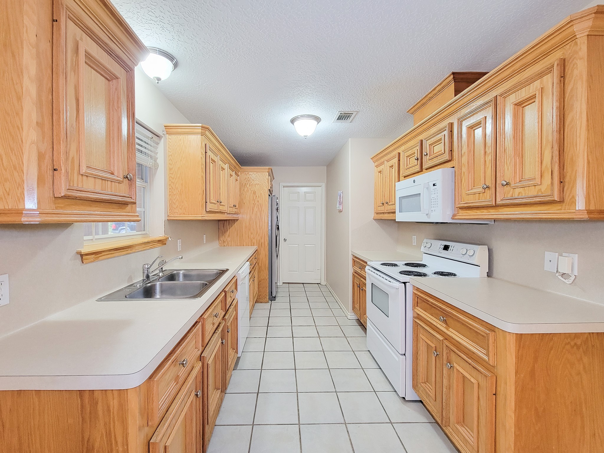 1000 Shell Avenue Cleveland, TX 77327 - Photo 14 of 34 a kitchen with stainless steel appliances granite countertop a sink and cabinets