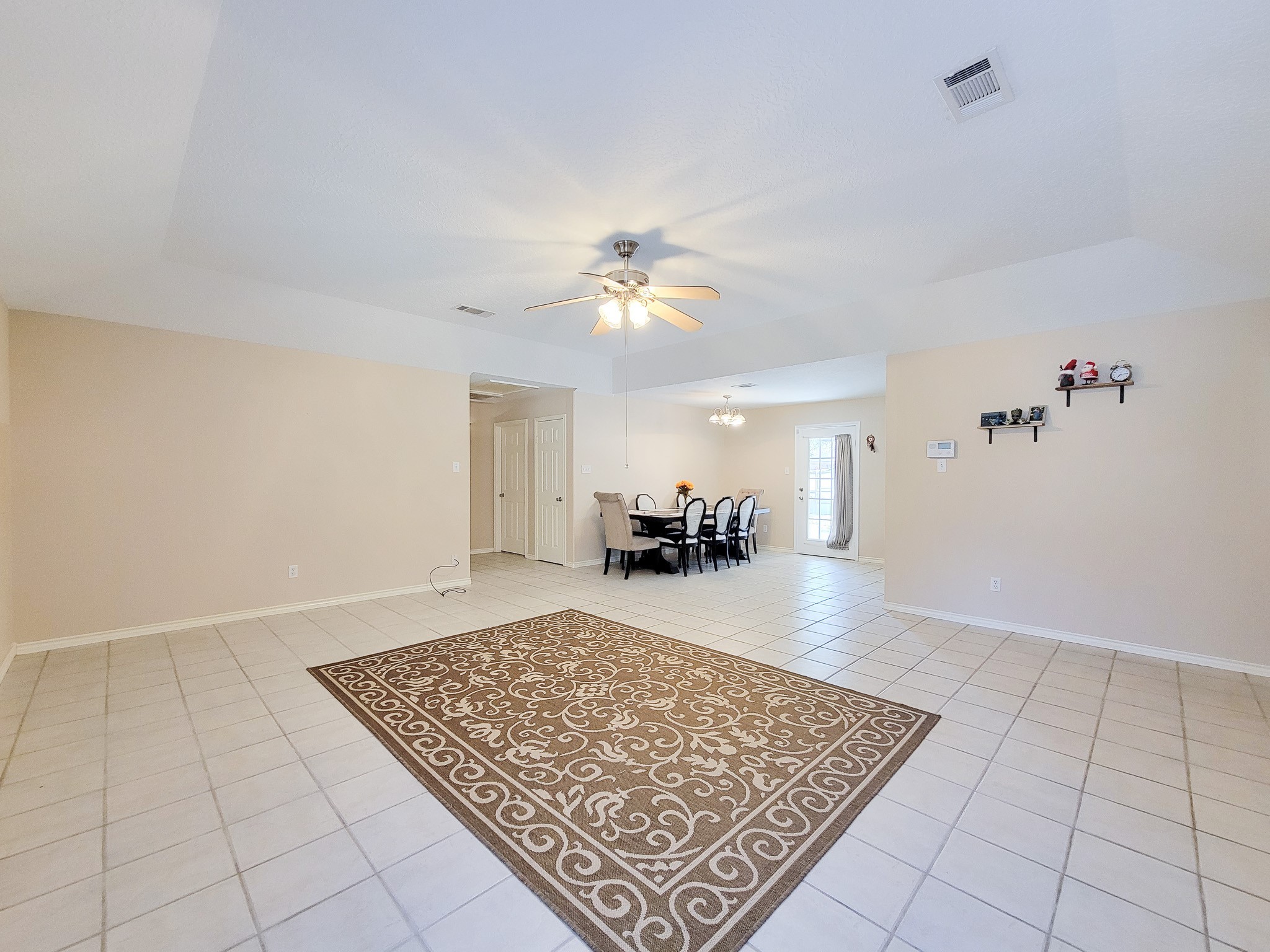 1000 Shell Avenue Cleveland, TX 77327 - Photo 7 of 34 wooden floor in a room with a table and a chandelier