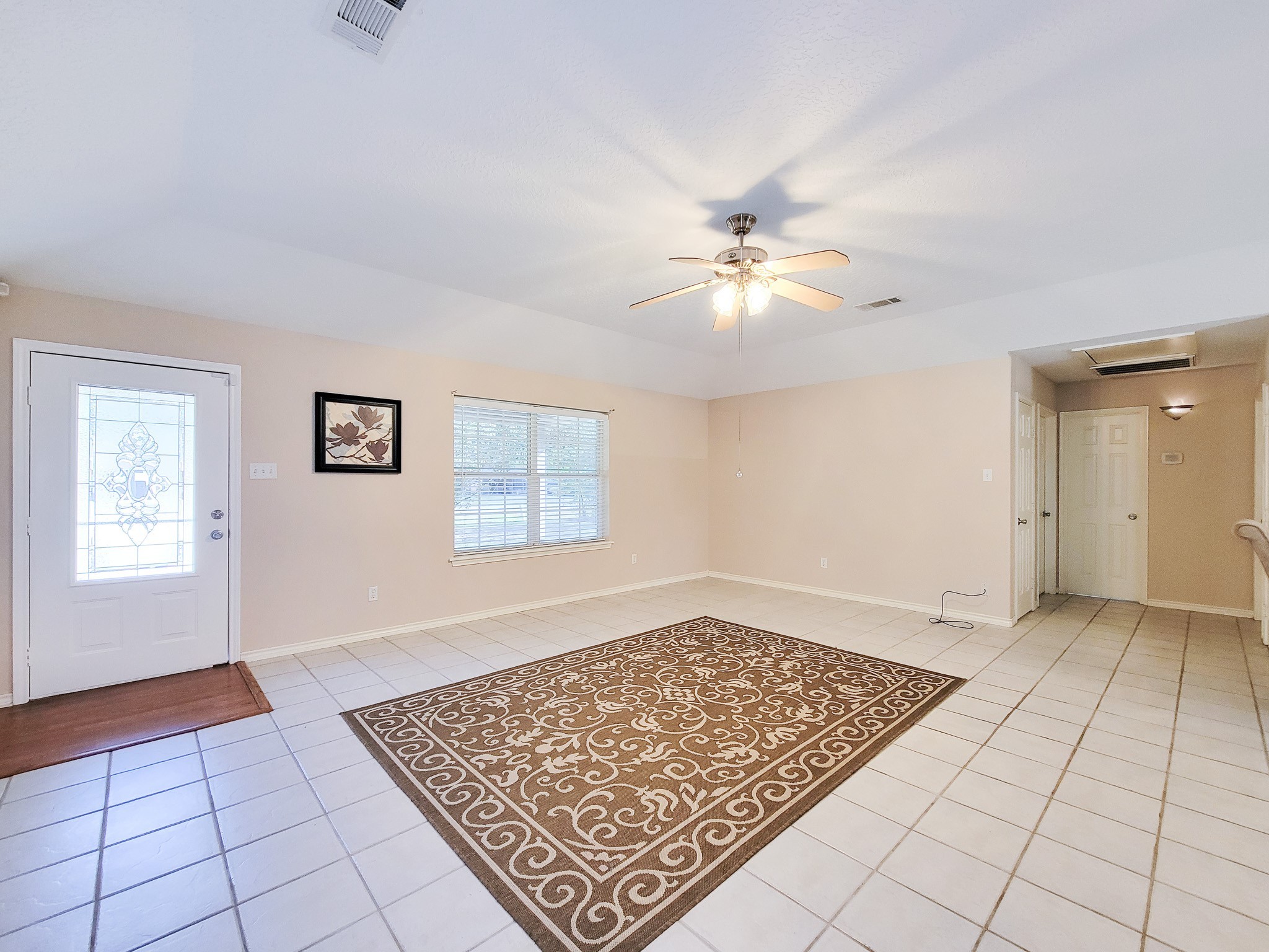 1000 Shell Avenue Cleveland, TX 77327 - Photo 9 of 34 a view of an empty room with window and chandelier fan