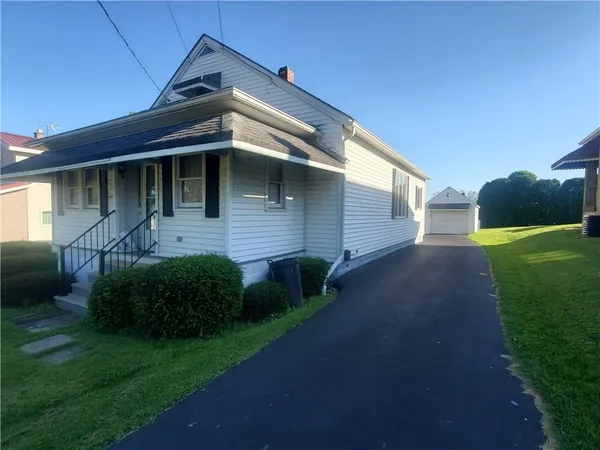 a view of a house with a small yard and a large window