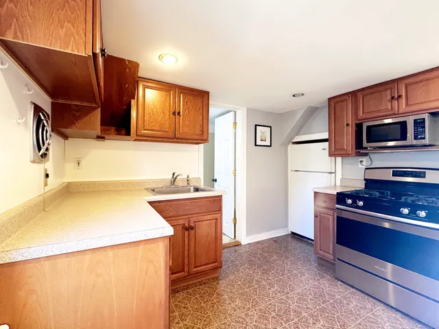 a kitchen with a stove and a refrigerator