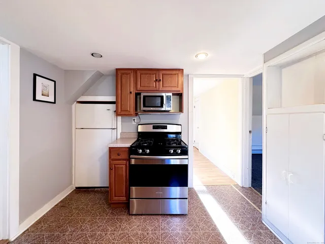 a kitchen with stainless steel appliances a stove a sink and a microwave