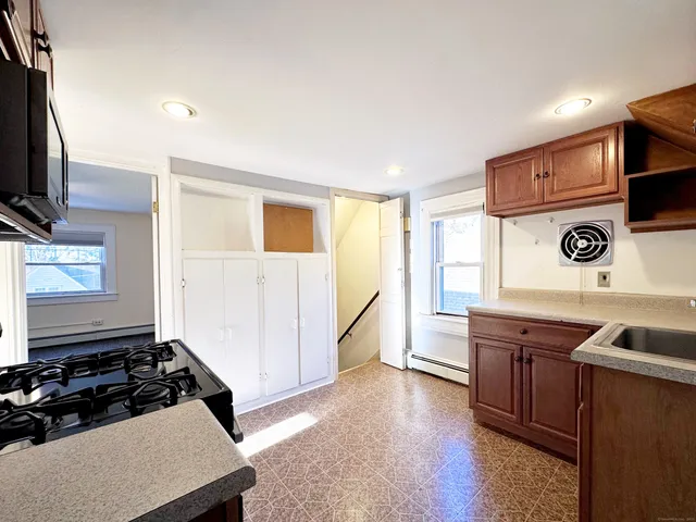 a kitchen with stainless steel appliances granite countertop a stove and a sink