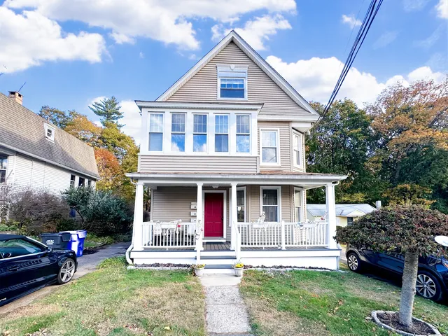 a front view of a house with a garden and plants