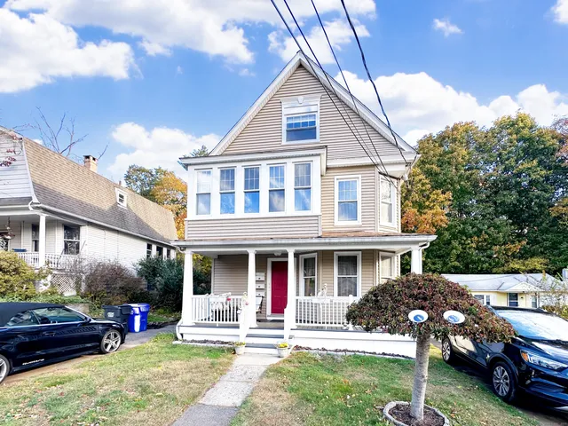 a front view of a house with a yard table and chairs