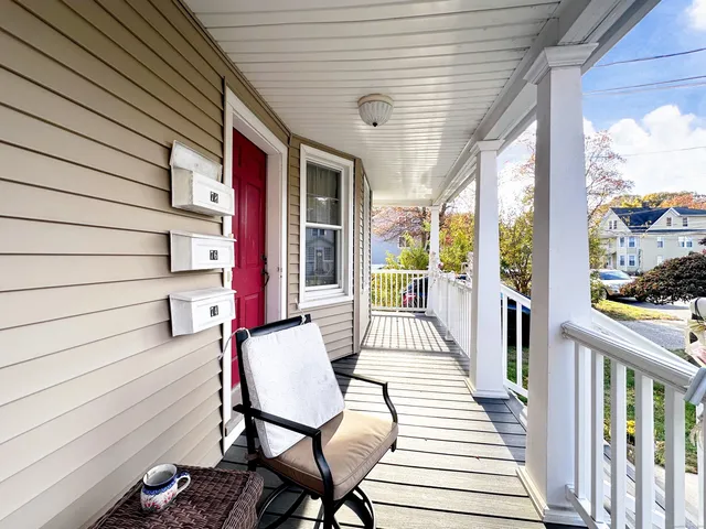 a balcony with chairs and wooden floor
