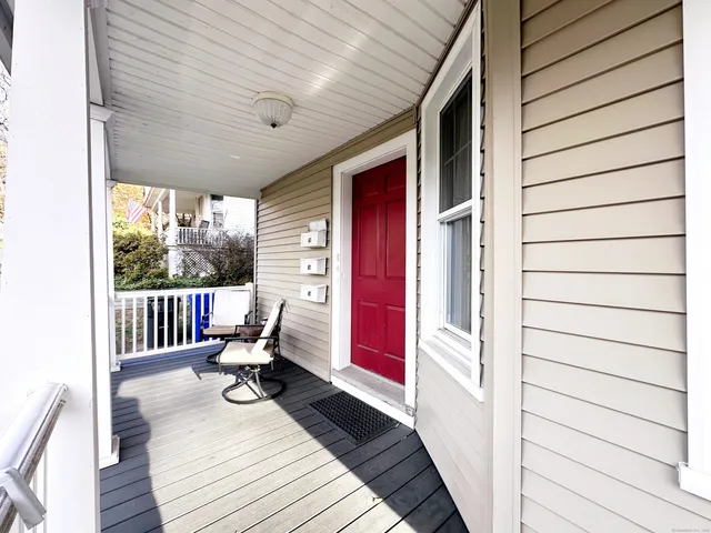a view of hallway with wooden floor and stairs