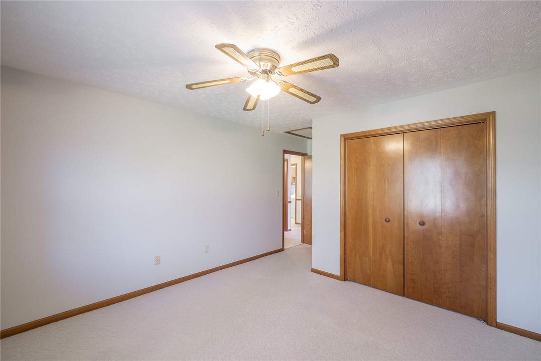 276 South Fairfield Road Bellbrook, OH 45305 - Photo 29 of 38 This spacious bedroom offers comfortable carpeting and a ceiling fan, creating a welcoming retreat.
